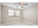 This bedroom features a ceiling fan, a large window, and neutral paint color at 5980 80Th St N # 106, St Petersburg, FL 33709