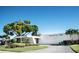 Magnolia Sun Center community building with a manicured lawn and landscaping at 5980 80Th St N # 106, St Petersburg, FL 33709