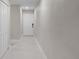 Hallway with light tile flooring and a white door at 5980 80Th St N # 106, St Petersburg, FL 33709