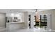 Modern kitchen featuring stainless steel appliances, white cabinetry, and a stacked washer/dryer unit at 5980 80Th St N # 106, St Petersburg, FL 33709