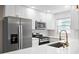 Stylish kitchen featuring stainless steel appliances, quartz countertops, and a tile backsplash at 5980 80Th St N # 106, St Petersburg, FL 33709