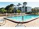 Outdoor community pool with a variety of seating and lovely grounds at 5980 80Th St N # 106, St Petersburg, FL 33709