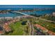 Beautiful aerial view featuring a golf course and condos with a bridge in the background with blue water views at 6191 Bahia Del Mar Blvd # 103, St Petersburg, FL 33715
