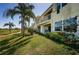 Beautiful backyard with lush landscaping, green grass, and a view of the golf course at 6191 Bahia Del Mar Blvd # 103, St Petersburg, FL 33715