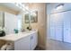 Inviting bathroom with a single vanity, mirrored wall, and abundant storage space at 6191 Bahia Del Mar Blvd # 103, St Petersburg, FL 33715