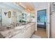 Elegant bathroom showcasing granite countertops, dual sinks, and seamless access to bedroom at 6191 Bahia Del Mar Blvd # 103, St Petersburg, FL 33715