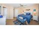 Bright bedroom with stylish decor, ceiling fan, and convenient access to adjacent areas at 6191 Bahia Del Mar Blvd # 103, St Petersburg, FL 33715
