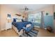 Comfortable bedroom featuring stylish decor and ample natural light from a large window at 6191 Bahia Del Mar Blvd # 103, St Petersburg, FL 33715