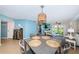 Dining area with a table set for four and a view into the living room at 6191 Bahia Del Mar Blvd # 103, St Petersburg, FL 33715