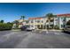 Exterior of the condo featuring a parking lot, manicured landscaping, and easy access stairs to the units at 6191 Bahia Del Mar Blvd # 103, St Petersburg, FL 33715