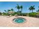 Inviting hot tub and spa with tropical landscaping, surrounded by lounge chairs at 6191 Bahia Del Mar Blvd # 103, St Petersburg, FL 33715