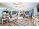 Inviting living area with neutral tones, ceiling fan, and access to the dining and kitchen spaces at 6191 Bahia Del Mar Blvd # 103, St Petersburg, FL 33715