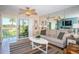 Cozy living room featuring neutral tones, comfortable seating, and a sliding glass door to the outside at 6191 Bahia Del Mar Blvd # 103, St Petersburg, FL 33715