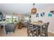Open-concept living space with dining table and view to the living room and outdoor space at 6191 Bahia Del Mar Blvd # 103, St Petersburg, FL 33715
