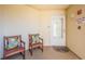 Comfortable outdoor patio area featuring seating, an alarm, and a well-maintained door at 6191 Bahia Del Mar Blvd # 103, St Petersburg, FL 33715