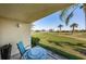 Outdoor patio features views of a lush golf course and tropical palm trees at 6191 Bahia Del Mar Blvd # 103, St Petersburg, FL 33715