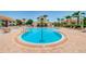 Inviting swimming pool with lounge chairs, tropical landscaping, and clubhouse at 6191 Bahia Del Mar Blvd # 103, St Petersburg, FL 33715