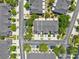 Aerial view of townhome community, highlighting manicured lawns, tree-lined streets, gray roofs, and ample parking at 6910 Rock Springs Way, Tampa, FL 33625