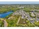 Overhead view of townhome community near lake, fountain, and trees showing parking, roads, and nearby highway access at 6910 Rock Springs Way, Tampa, FL 33625