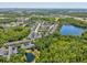 Aerial view of the real estate community including pool, surrounding lakes, and well-manicured landscaping at 6910 Rock Springs Way, Tampa, FL 33625
