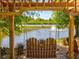 Relax on the backyard swing while enjoying serene pond views with a fountain feature at 6910 Rock Springs Way, Tampa, FL 33625