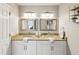Bathroom featuring double sinks, granite countertops, and framed mirrors at 6910 Rock Springs Way, Tampa, FL 33625