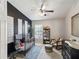 Stylishly decorated Bedroom with a crib, rocking chair, decorative rug and dark accent wall at 6910 Rock Springs Way, Tampa, FL 33625