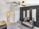 Comfortable Bedroom with black accent wall, stylish crib, and ceiling fan at 6910 Rock Springs Way, Tampa, FL 33625