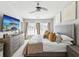 Bright bedroom featuring a plush bed with decorative pillows, neutral tones, and large windows at 6910 Rock Springs Way, Tampa, FL 33625