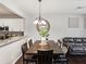Inviting dining area with wooden table, elegant chandelier, and a seamless transition to the adjacent living space at 6910 Rock Springs Way, Tampa, FL 33625
