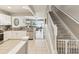 Open-concept kitchen flowing into the living area, featuring white cabinets, granite countertops, and stainless steel appliances at 6910 Rock Springs Way, Tampa, FL 33625