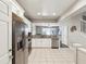Modern kitchen with white cabinets, granite countertops, stainless steel appliances, and an open view to the living area at 6910 Rock Springs Way, Tampa, FL 33625