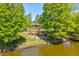 Scenic view of lake from beneath the pergola, a perfect spot for relaxation and enjoying the serene surroundings at 6910 Rock Springs Way, Tampa, FL 33625