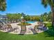 Beautiful community pool with lush landscaping, lounge seating, and a relaxing atmosphere at 6910 Rock Springs Way, Tampa, FL 33625