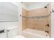 Well-lit bathroom features tiled shower/tub, neutral tones, and modern fixtures at 7309 N Huntley Ave, Tampa, FL 33604