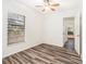 Bright bedroom with wood flooring, and natural light from a large window at 7309 N Huntley Ave, Tampa, FL 33604