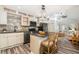 Stylish kitchen with gray backsplash, granite counters, and stainless steel appliances and center island at 7309 N Huntley Ave, Tampa, FL 33604