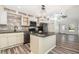 Open kitchen boasts stainless appliances, granite island, and an eat-in space at 7309 N Huntley Ave, Tampa, FL 33604