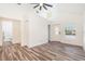 Open living area with wood floors, white walls, and ample natural light at 7309 N Huntley Ave, Tampa, FL 33604