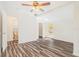 Open living area with modern flooring, lots of light and access to the bathroom at 7309 N Huntley Ave, Tampa, FL 33604