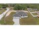 Overhead shot of a home with a three-car garage and an expansive driveway surrounded by trees at 7372 Madrid Rd, Weeki Wachee, FL 34613