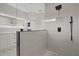 Modern bathroom featuring a glass shower enclosure with rainfall showerhead, white tile, and vanity with stylish fixtures at 7372 Madrid Rd, Weeki Wachee, FL 34613