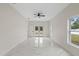 Bright bedroom with stylish marble flooring, large windows, and modern ceiling fan at 7372 Madrid Rd, Weeki Wachee, FL 34613