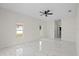 Spacious bedroom with light, shiny marble flooring and a ceiling fan at 7372 Madrid Rd, Weeki Wachee, FL 34613