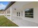 Relax on the covered patio, featuring a ceiling fan and marble tile flooring at 7372 Madrid Rd, Weeki Wachee, FL 34613