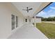 Covered patio with ceiling fans offers a comfortable outdoor living space at 7372 Madrid Rd, Weeki Wachee, FL 34613