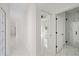 Bright hallway with marble floors leading to bedrooms and bathrooms, enhancing the home's modern and spacious design at 7372 Madrid Rd, Weeki Wachee, FL 34613