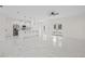 Bright kitchen featuring marble floors, modern white cabinets, a large island, and stainless steel appliances at 7372 Madrid Rd, Weeki Wachee, FL 34613