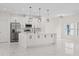 Modern kitchen with stainless steel appliances, an island, and pendant lighting highlighting the white cabinetry at 7372 Madrid Rd, Weeki Wachee, FL 34613