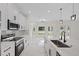 Stylish kitchen featuring a marble island with sleek appliances and bright lighting at 7372 Madrid Rd, Weeki Wachee, FL 34613